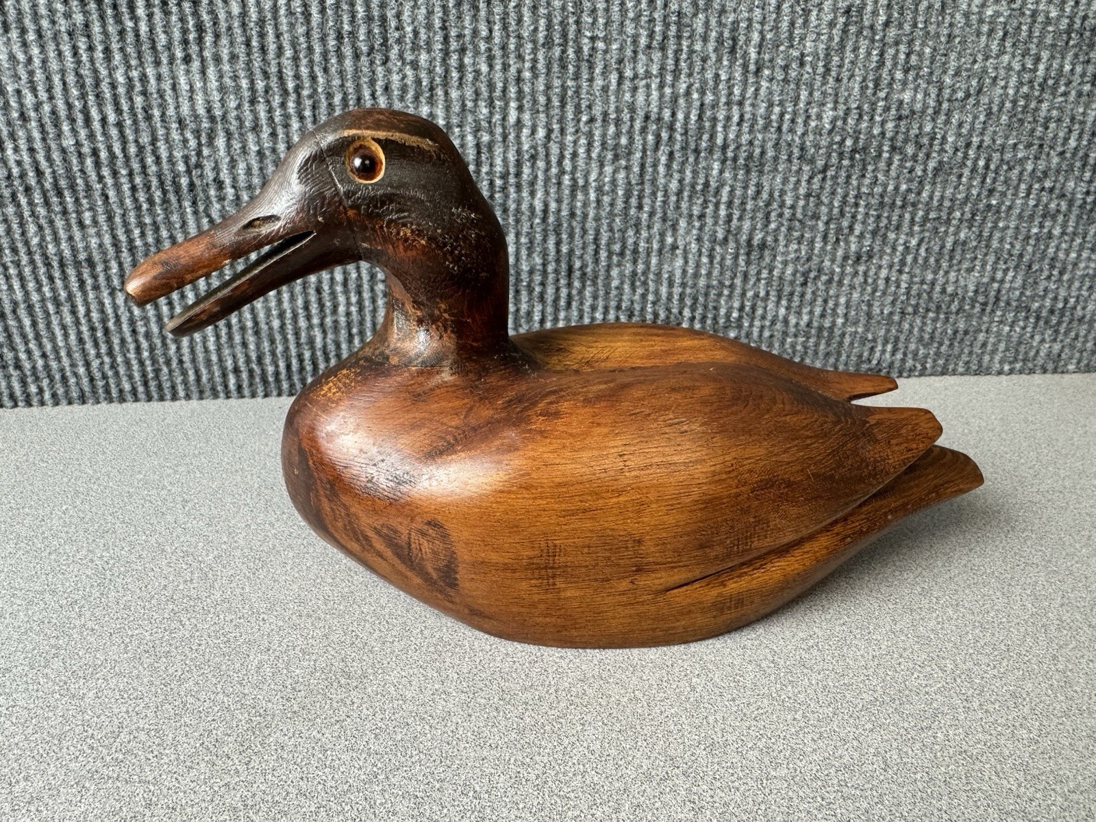 Vintage 1978 hand-carved wood duck decoy with glass eyes, stamped E. Buck.