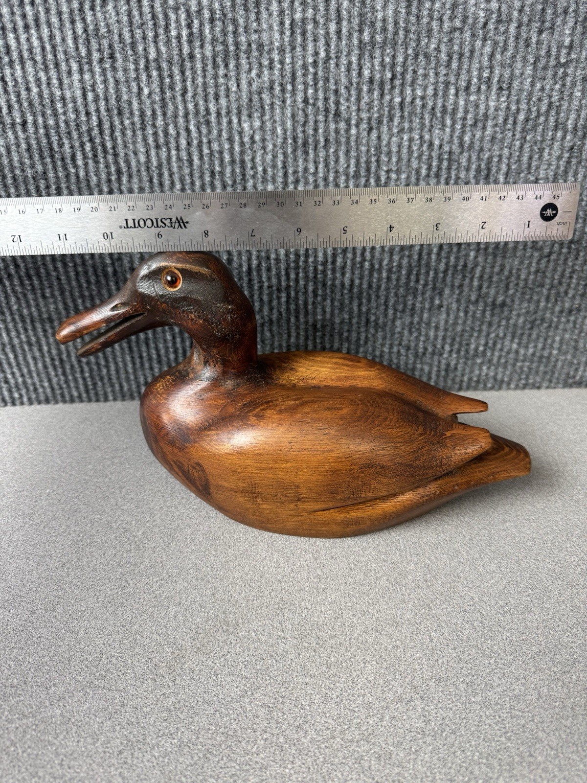 Vintage 1978 hand-carved wood duck decoy with glass eyes, stamped E. Buck.